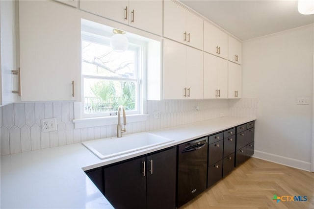 kitchen with a sink, decorative backsplash, white cabinetry, and dishwasher