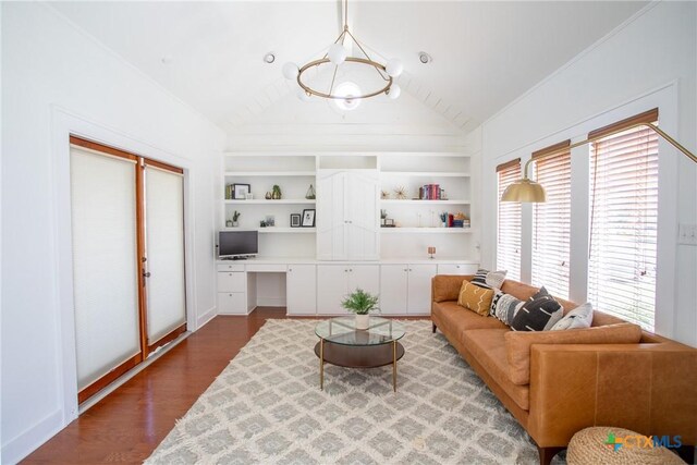 living room with vaulted ceiling, built in shelves, wood finished floors, built in study area, and baseboards