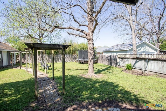 view of yard featuring a fenced backyard and a trampoline