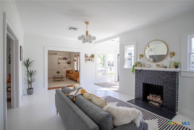living area featuring visible vents, crown molding, a chandelier, and a fireplace