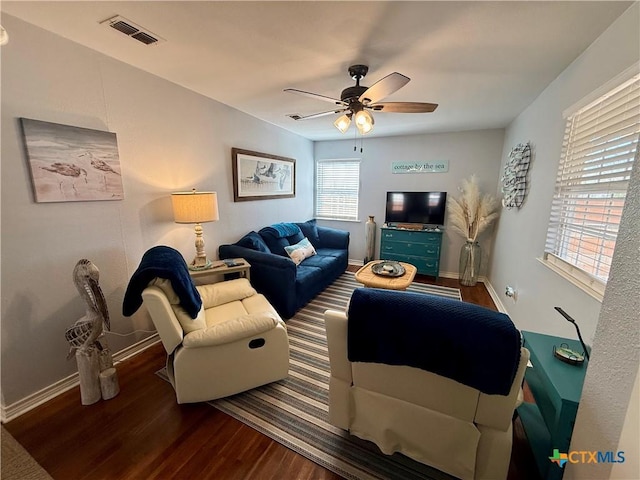 living room with ceiling fan and dark hardwood / wood-style flooring