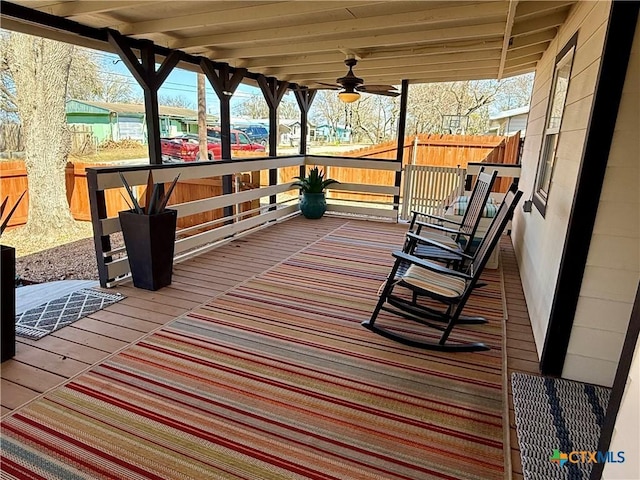 deck with ceiling fan and covered porch