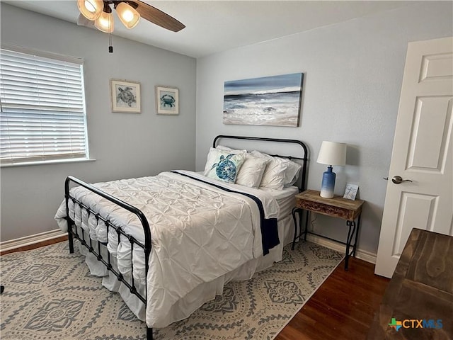 bedroom featuring dark wood-type flooring and ceiling fan