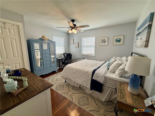 bedroom with dark hardwood / wood-style floors and ceiling fan