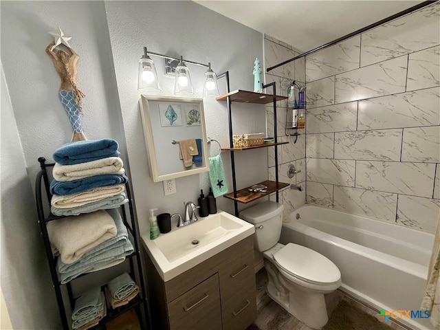 full bathroom featuring vanity, tiled shower / bath combo, and toilet