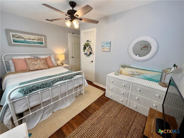 bedroom with dark wood-type flooring and ceiling fan