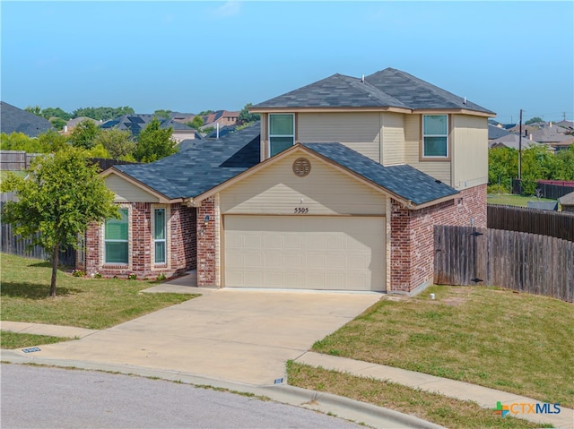 view of front of house with a garage and a front yard