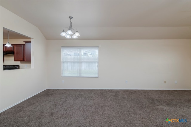 empty room with dark colored carpet, lofted ceiling, and an inviting chandelier