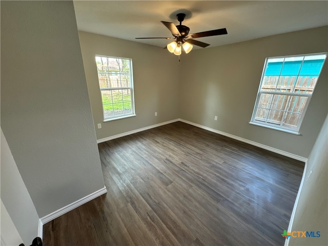 empty room featuring ceiling fan and dark hardwood / wood-style floors