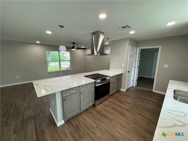3004 Mayfair Dr, Victoria, TX 77901 - kitchen with island exhaust hood, electric stove, dark wood finished floors, a peninsula, and baseboards