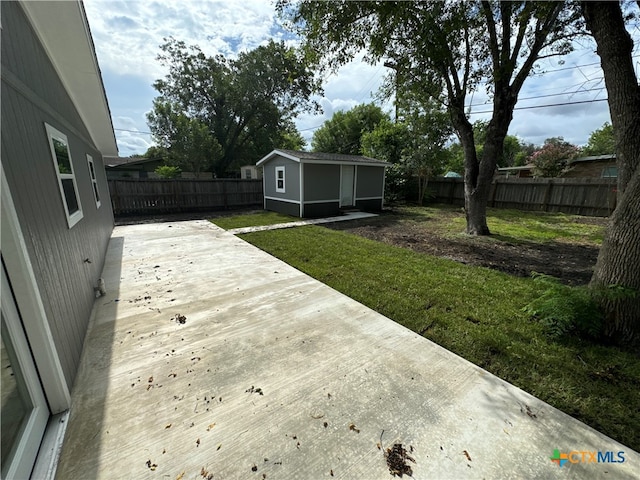 wooden terrace with an outbuilding, a patio area, and a lawn