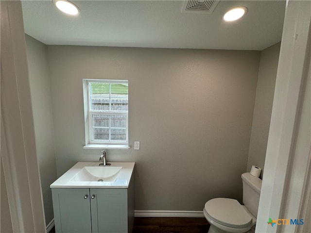 3004 Mayfair Dr, Victoria, TX 77901 - bathroom featuring vanity, toilet, baseboards, wood finished floors, and recessed lighting