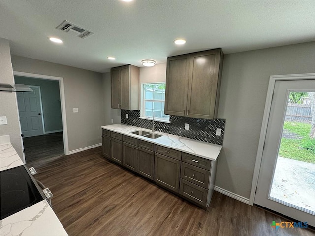 3004 Mayfair Dr, Victoria, TX 77901 - kitchen featuring a sink, dark wood-type flooring, backsplash, baseboards, and healthy amount of natural light