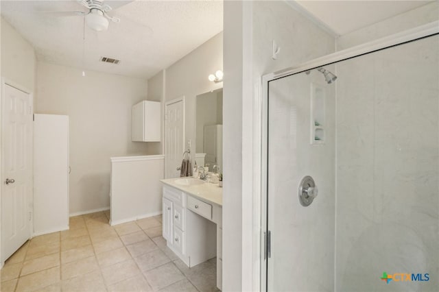 7401 Napier Trl, Austin, TX 78729 - full bath with vanity, a stall shower, a ceiling fan, and tile patterned floors