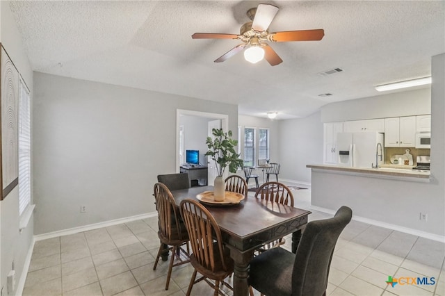 7401 Napier Trl, Austin, TX 78729 - dining area featuring a textured ceiling, light tile patterned floors, a ceiling fan, and lofted ceiling