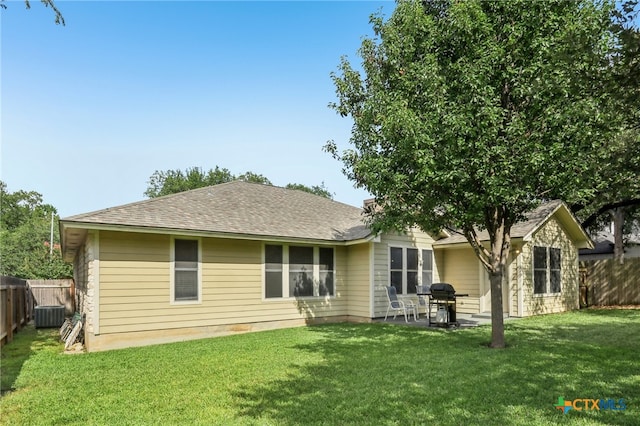 7401 Napier Trl, Austin, TX 78729 - back of property with a fenced backyard, a shingled roof, and a patio