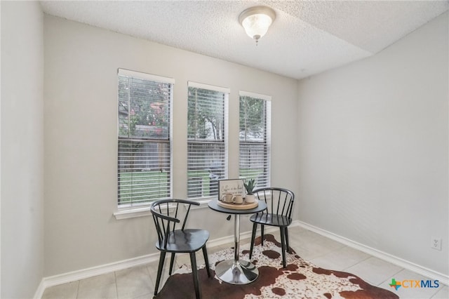 7401 Napier Trl, Austin, TX 78729 - dining room featuring a textured ceiling and light tile patterned floors