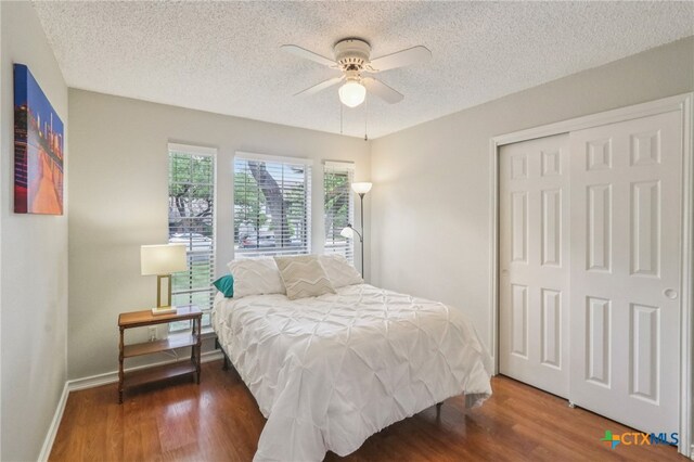 7401 Napier Trl, Austin, TX 78729 - bedroom featuring a textured ceiling, wood finished floors, a closet, and a ceiling fan