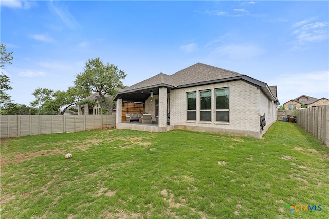 343 Sugarcane, New Braunfels, TX 78132 - back of house featuring a fenced backyard, a yard, roof with shingles, a patio, and brick siding
