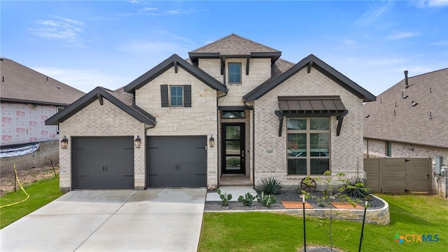 343 Sugarcane, New Braunfels, TX 78132 - view of front of home featuring fence, a front lawn, concrete driveway, stone siding, and a garage
