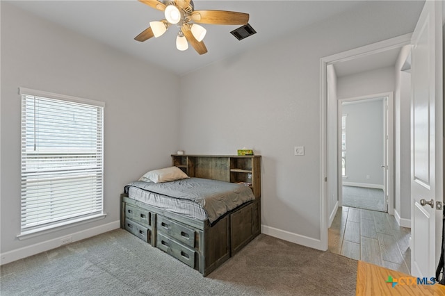 343 Sugarcane, New Braunfels, TX 78132 - bedroom with baseboards, a ceiling fan, and multiple windows