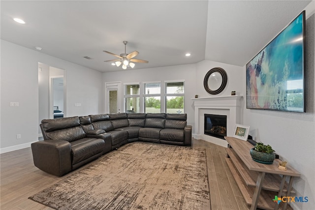 343 Sugarcane, New Braunfels, TX 78132 - living room featuring a glass covered fireplace, wood finished floors, visible vents, and a ceiling fan