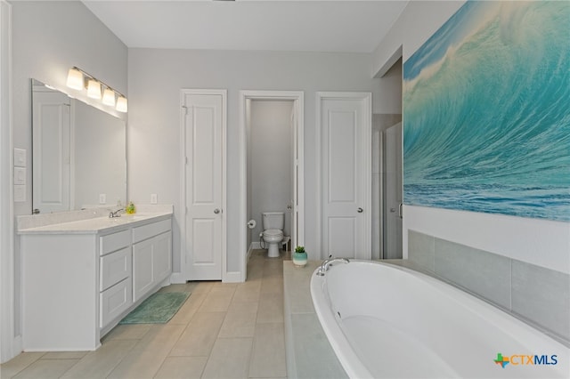 343 Sugarcane, New Braunfels, TX 78132 - full bath featuring tile patterned flooring, toilet, vanity, baseboards, and a garden tub