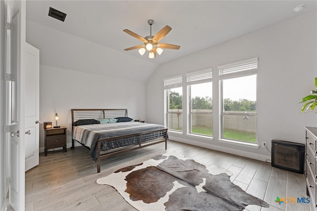 343 Sugarcane, New Braunfels, TX 78132 - bedroom with light wood-style floors, vaulted ceiling, visible vents, and a ceiling fan