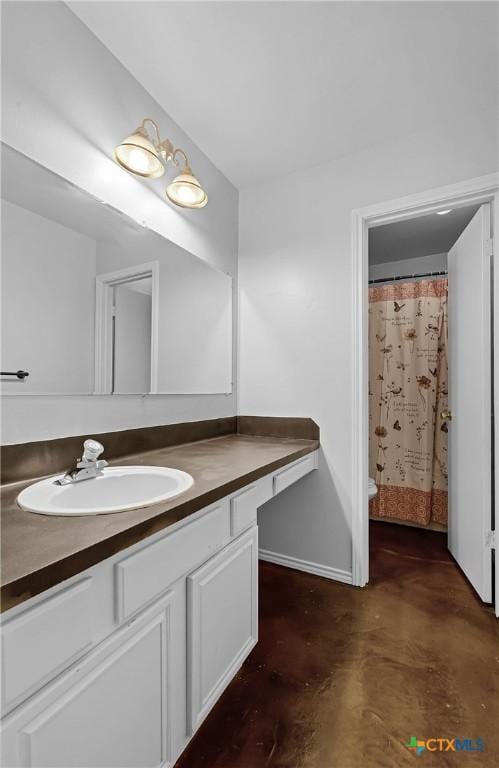 bathroom with vanity, concrete flooring, and walk in shower