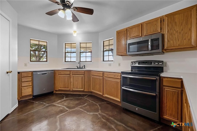 kitchen featuring ceiling fan, stainless steel appliances, a wealth of natural light, and sink