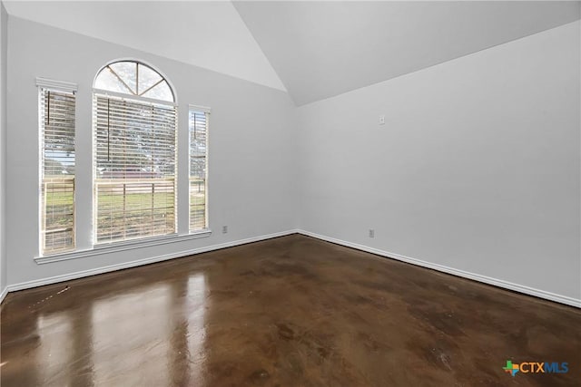 spare room with vaulted ceiling