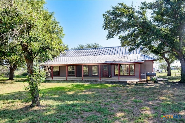 rear view of house with a yard and a patio area