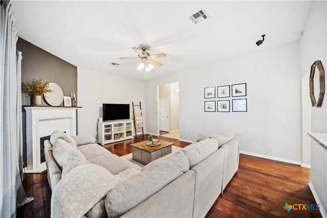 2627 Butterfly Dr, Temple, TX 76502 - living room with dark wood finished floors, ceiling fan, and baseboards