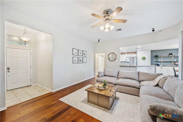 2627 Butterfly Dr, Temple, TX 76502 - living room with wood finished floors, a ceiling fan, and baseboards
