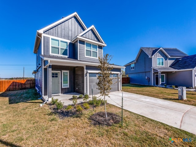 view of front of home featuring a garage and a front lawn