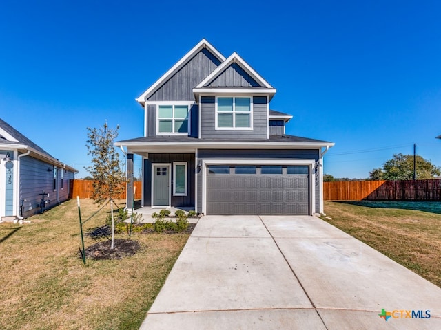 view of front of property with a garage and a front lawn