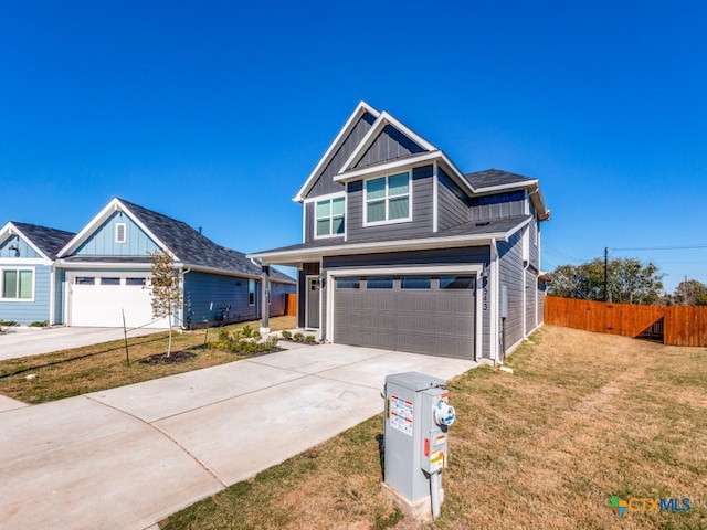 craftsman-style home featuring a garage and a front lawn