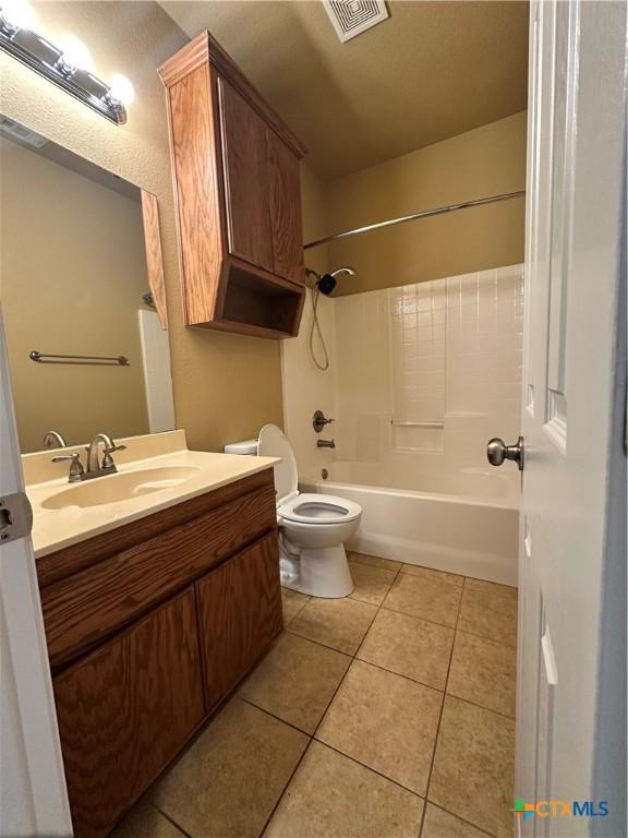 full bath with toilet, vanity, visible vents, and tile patterned floors