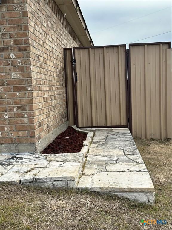 view of gate with fence