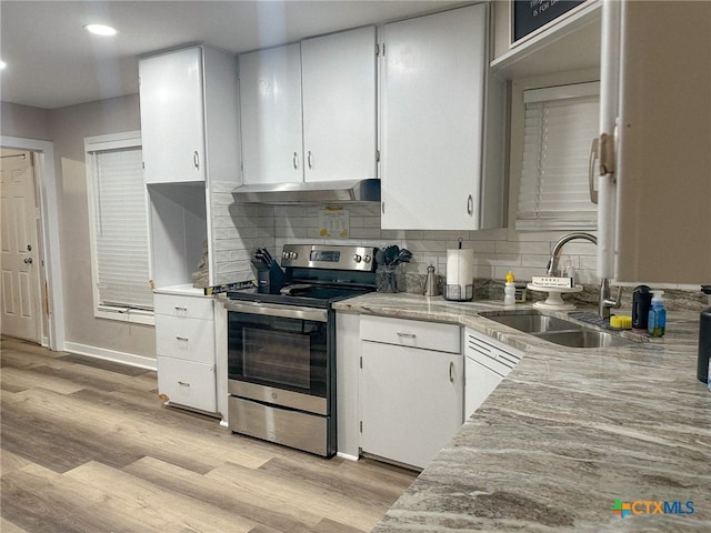 kitchen featuring white cabinetry, electric range, sink, and light hardwood / wood-style flooring