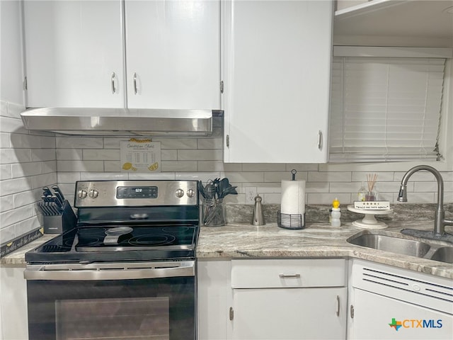 kitchen with backsplash, stainless steel range with electric cooktop, ventilation hood, sink, and white cabinetry