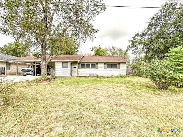 ranch-style house featuring a front yard and a carport