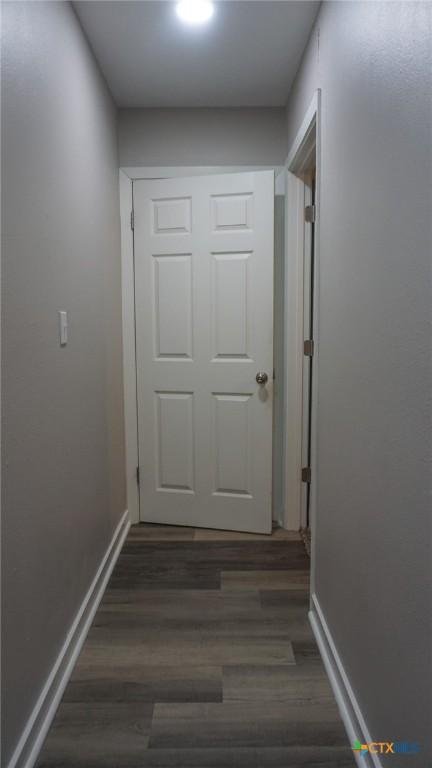 unfurnished room featuring dark hardwood / wood-style floors and a notable chandelier