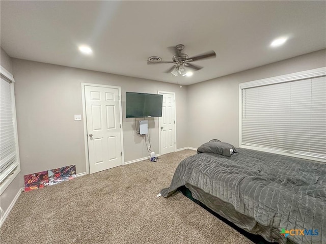 carpeted bedroom featuring ceiling fan