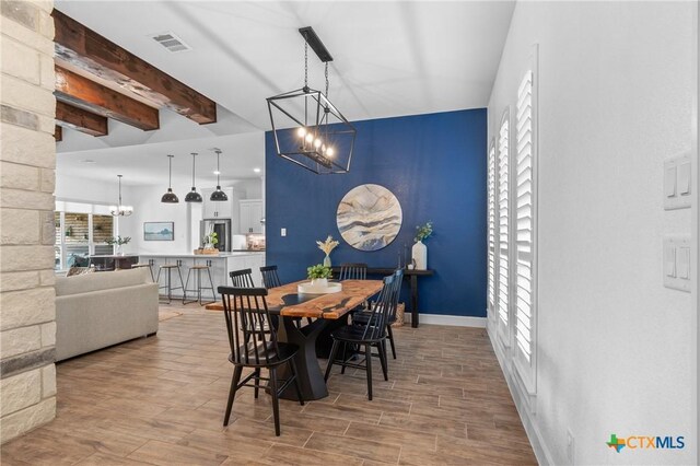 2037 Heritage Loop, Nolanville, TX 76559 - dining area with a chandelier, wood finished floors, and beamed ceiling