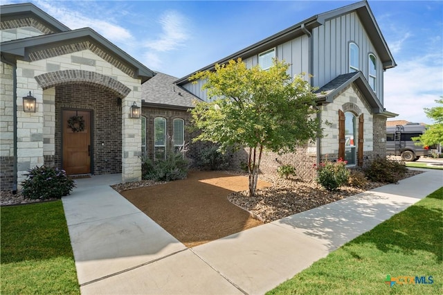 2037 Heritage Loop, Nolanville, TX 76559 - view of front of home featuring board and batten siding, brick siding, stone siding, and a shingled roof