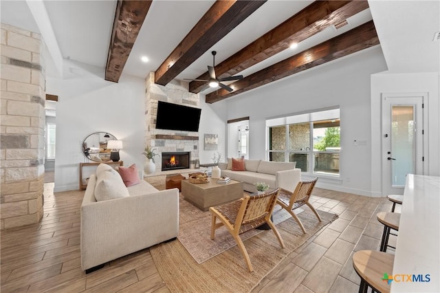 2037 Heritage Loop, Nolanville, TX 76559 - living area featuring a fireplace, ceiling fan, wood finish floors, and beamed ceiling