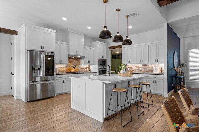 2037 Heritage Loop, Nolanville, TX 76559 - kitchen featuring appliances with stainless steel finishes, decorative backsplash, light wood-type flooring, white cabinetry, and recessed lighting