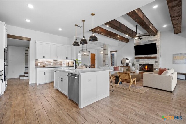2037 Heritage Loop, Nolanville, TX 76559 - kitchen with stainless steel appliances, a fireplace, open floor plan, beamed ceiling, and a ceiling fan