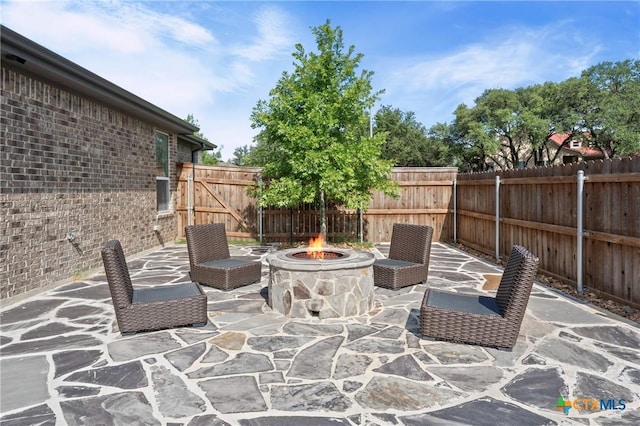 2037 Heritage Loop, Nolanville, TX 76559 - fenced backyard with an outdoor fire pit and a patio